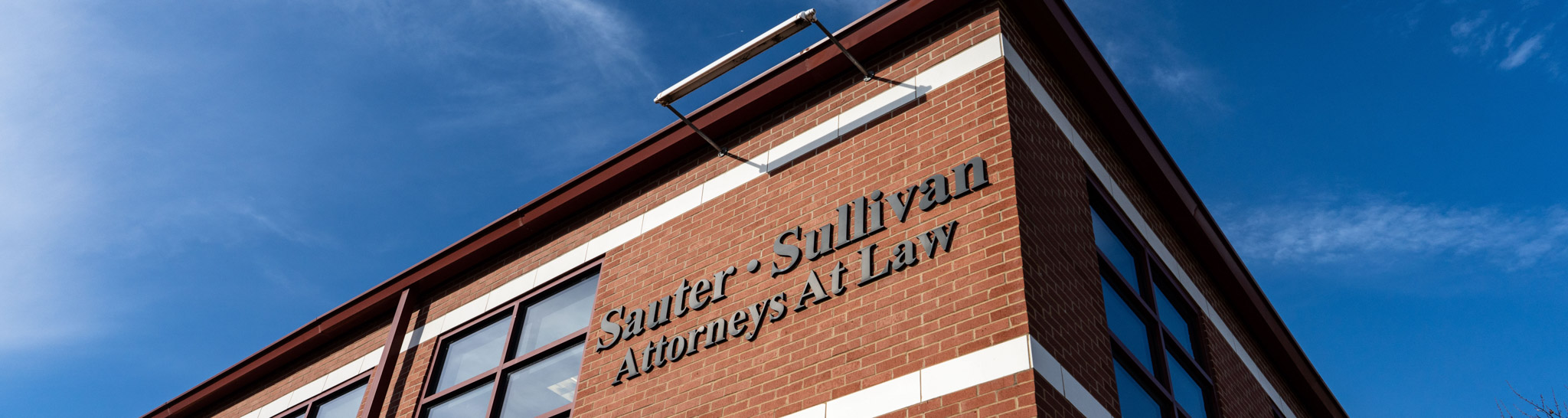 Sauter Sullivan Attorneys at Law building sign attached to brick wall