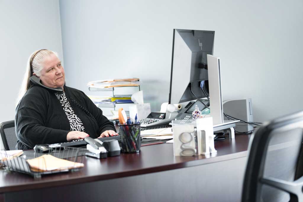 Gretchen Kolokithas working at her desk